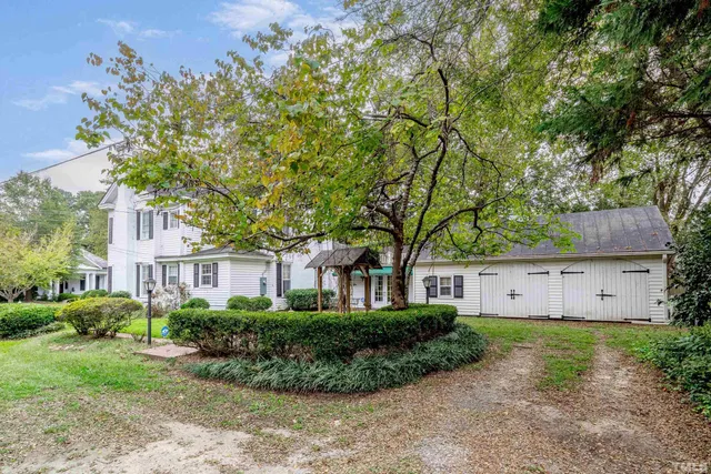 a front view of a house with patio and garden