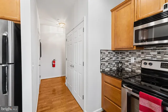 a kitchen with stainless steel appliances a stove a microwave and a refrigerator