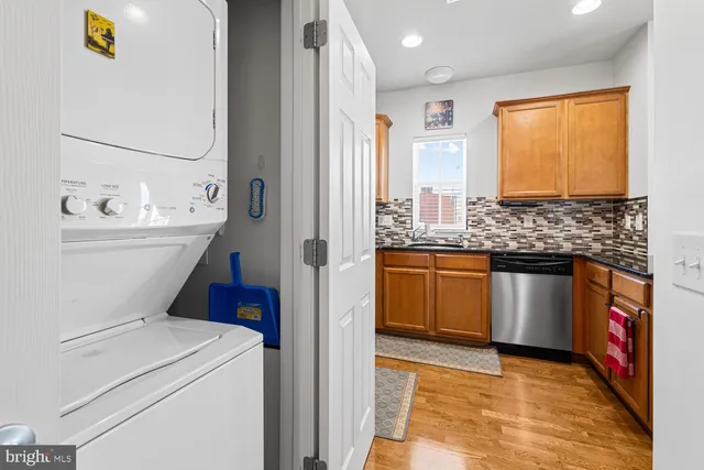 a view of washer and dryer with kitchen countertops