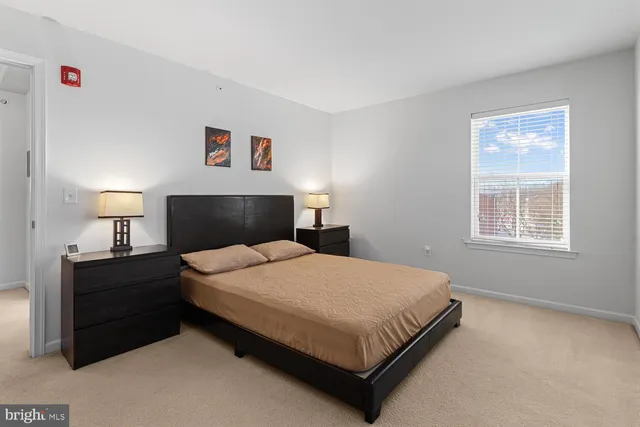 a bedroom with a bed and a night stand