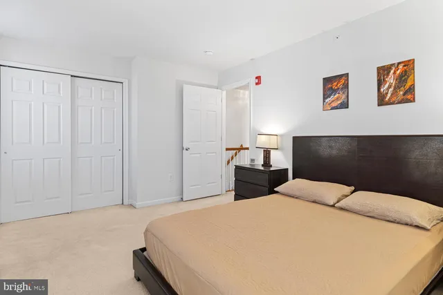 a bedroom with a bed and a painting on the wall