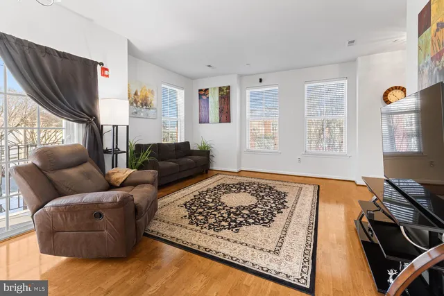 a living room with furniture window and a flat screen tv