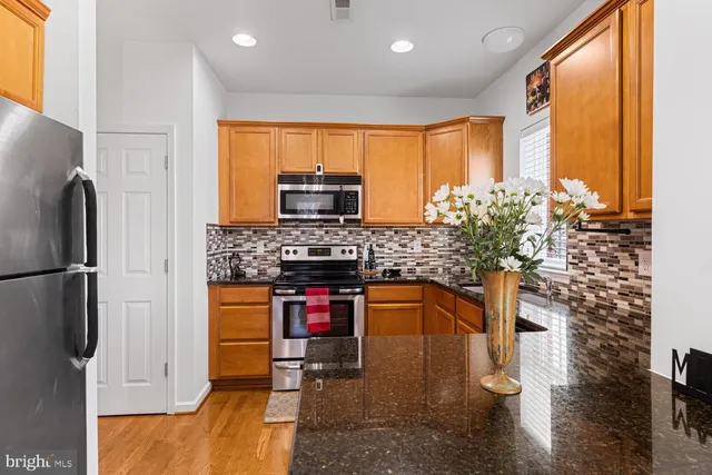a kitchen with stainless steel appliances a sink stove and refrigerator