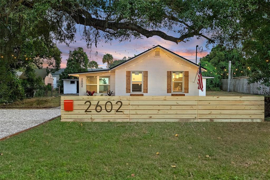 a front view of a house with patio and garden
