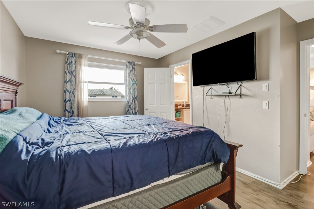 8454 Wren Road Fort Myers, FL 33967 - Photo 13 of 23 a bedroom with a bed tv and a window