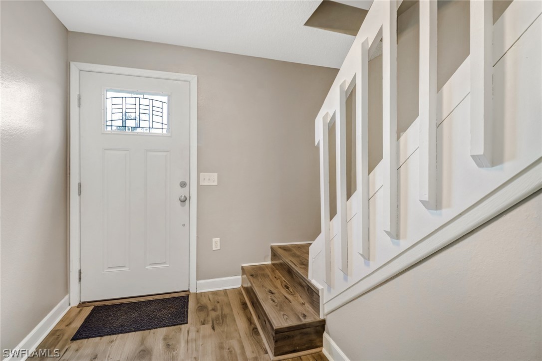 8454 Wren Road Fort Myers, FL 33967 - Photo 2 of 23 a view of an entryway with wooden floor