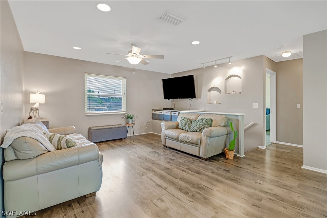 8454 Wren Road Fort Myers, FL 33967 - Photo 3 of 23 a living room with furniture and a flat screen tv