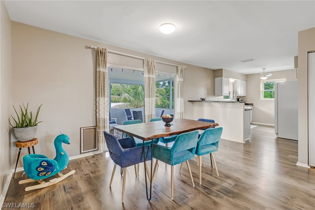 8454 Wren Road Fort Myers, FL 33967 - Photo 5 of 23 a dining room with furniture and wooden floor