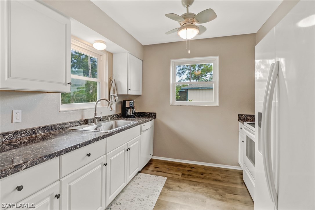 8454 Wren Road Fort Myers, FL 33967 - Photo 7 of 23 a bathroom with a granite countertop sink a mirror and a window