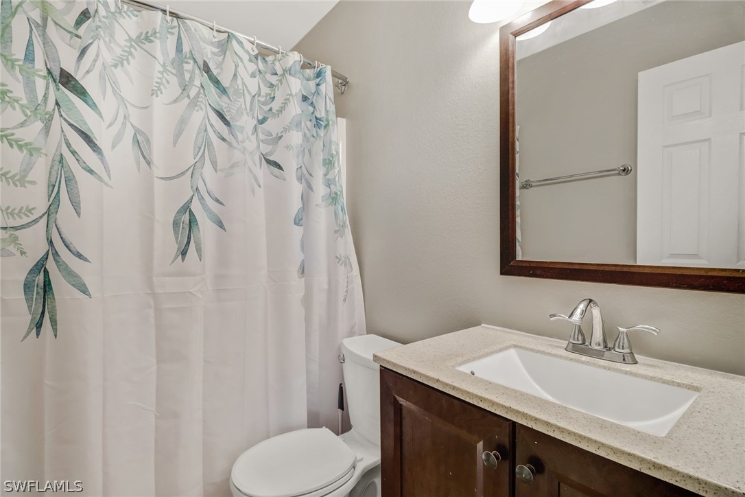 8454 Wren Road Fort Myers, FL 33967 - Photo 10 of 23 a bathroom with a granite countertop sink and a mirror