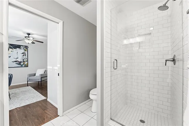 a bathroom with a granite countertop shower a toilet and a sink