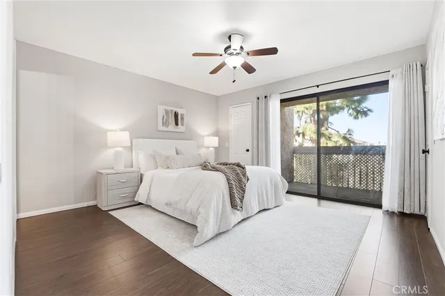 a spacious bedroom with a large bed and a chandelier