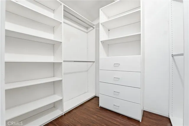 a view of walk in closet with empty racks