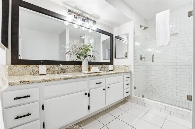 a bathroom with a granite countertop sink mirror and double
