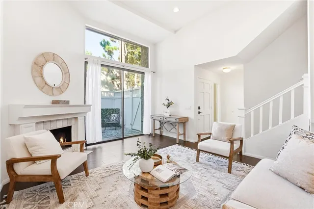 a living room with furniture a fireplace and a table