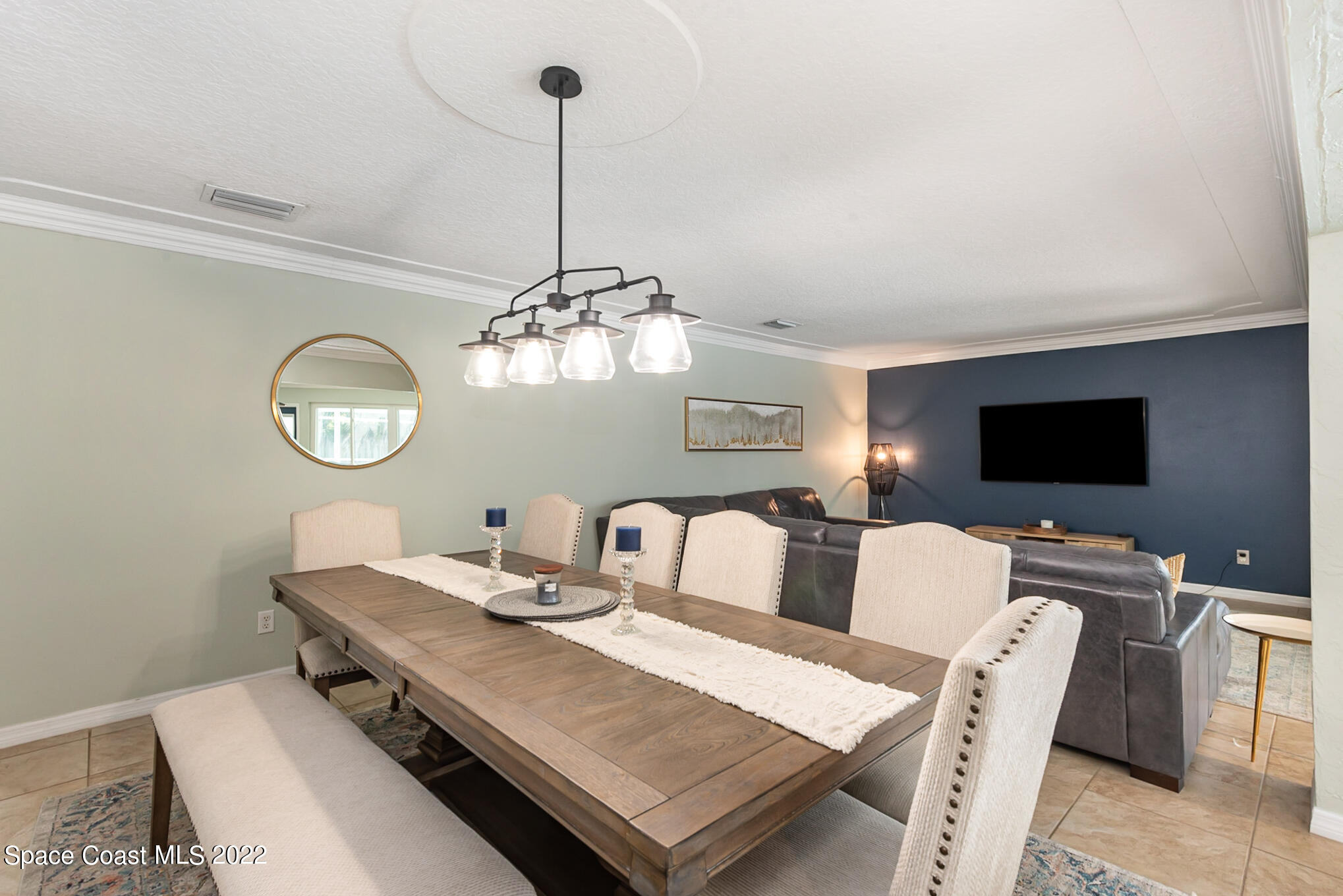 395 Rio Lane Indialantic, FL 32903 - Photo 15 of 40 a view of a dining room with furniture a chandelier and wooden floor