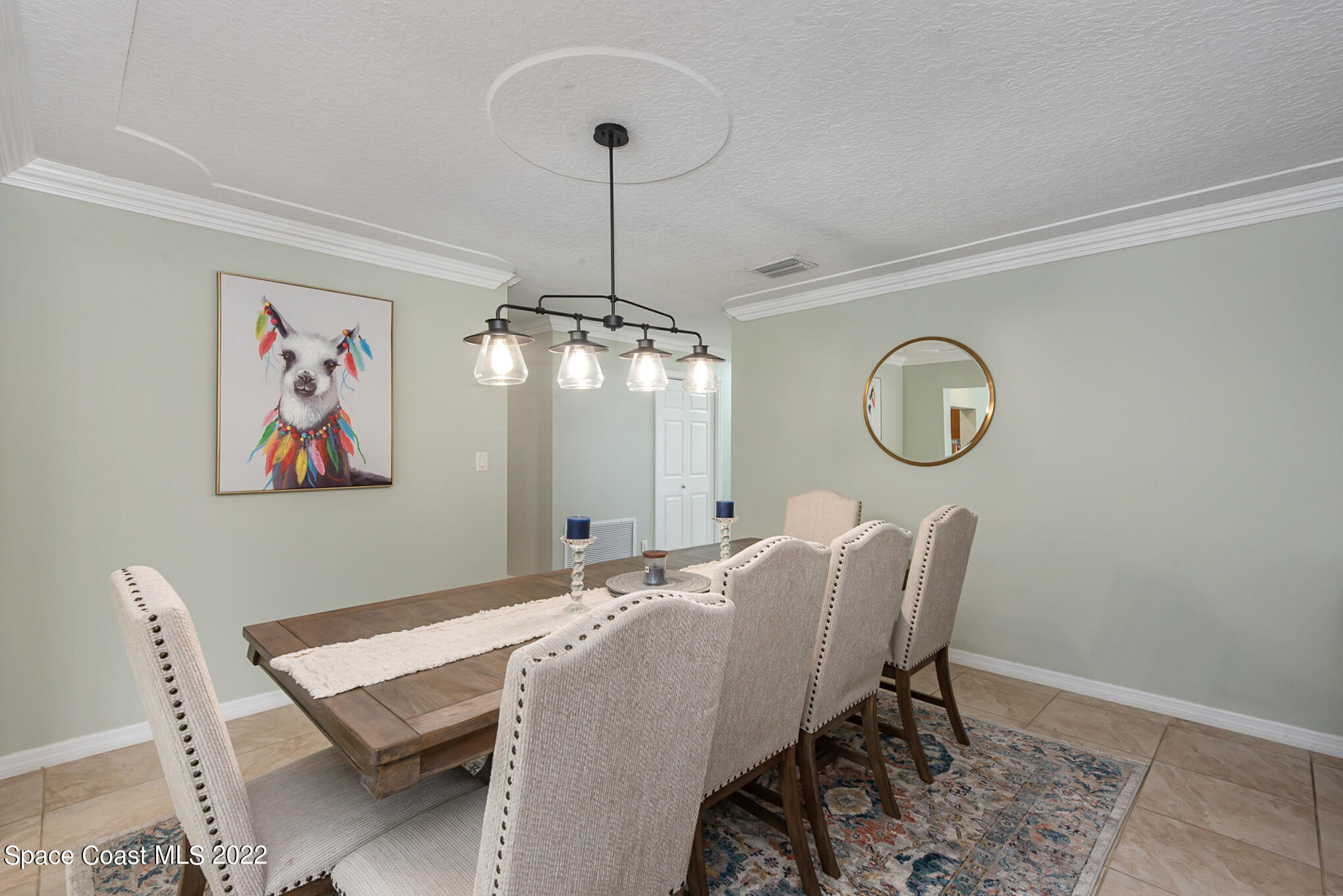 395 Rio Lane Indialantic, FL 32903 - Photo 16 of 40 a view of a dining room with furniture a chandelier and wooden floor