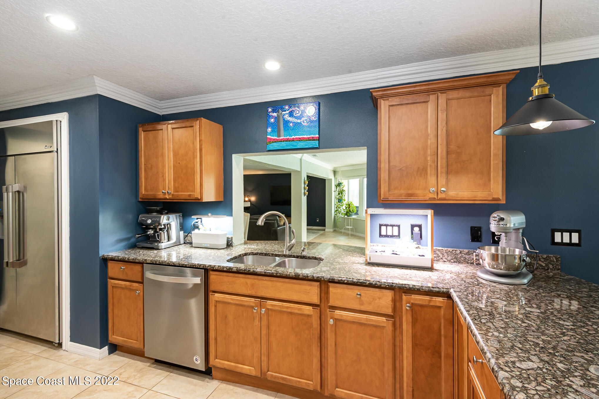 395 Rio Lane Indialantic, FL 32903 - Photo 18 of 40 a kitchen with stainless steel appliances granite countertop sink stove and refrigerator