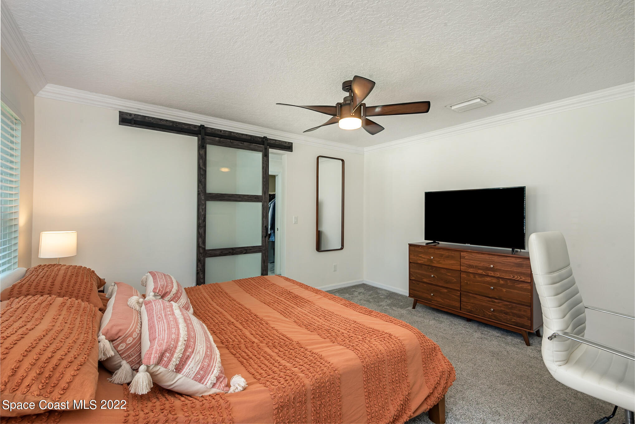 395 Rio Lane Indialantic, FL 32903 - Photo 25 of 40 a bedroom with a bed and a flat screen tv