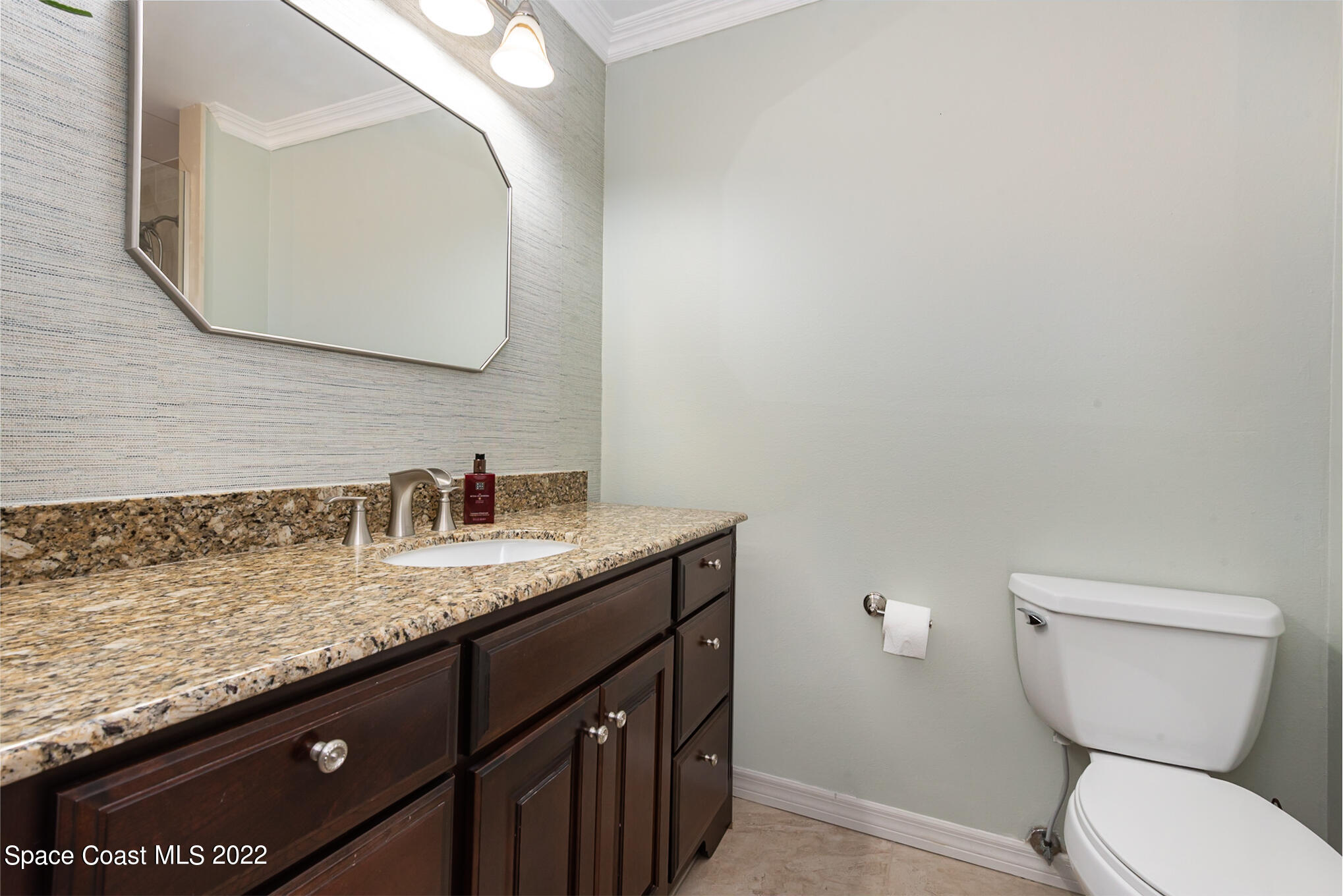 395 Rio Lane Indialantic, FL 32903 - Photo 28 of 40 a bathroom with a granite countertop toilet sink and mirror