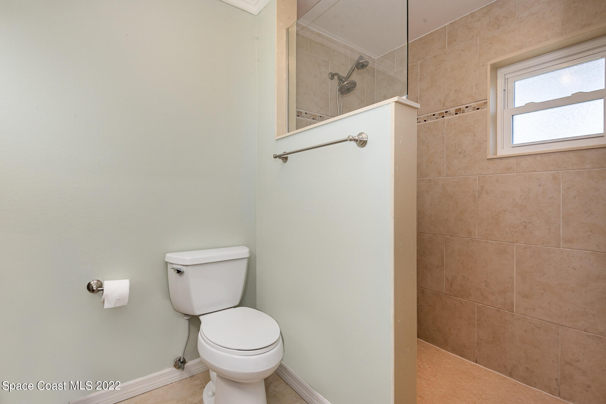 395 Rio Lane Indialantic, FL 32903 - Photo 29 of 40 a white toilet sitting next to a bathroom sink