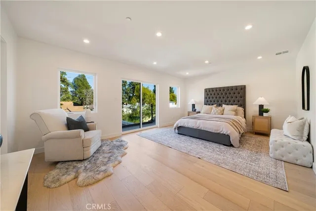 a spacious bedroom with a large bed and a couch