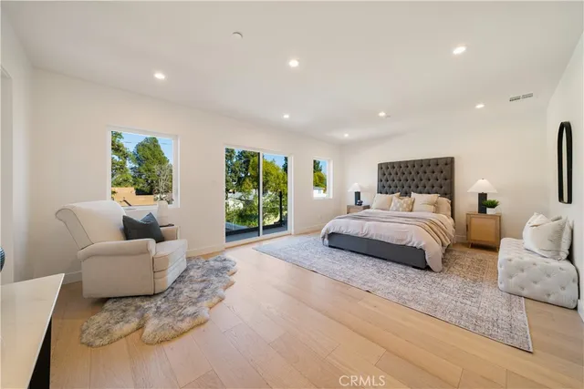 a bedroom with a large bed and a couch