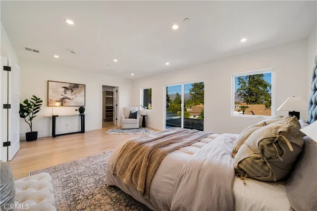 a spacious bedroom with a large bed and a couch