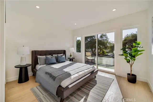 a bedroom with a bed and a potted plant