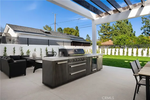 a view of a porch with chairs and backyard