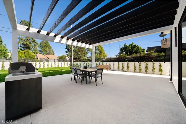 a view of a porch with chairs and backyard
