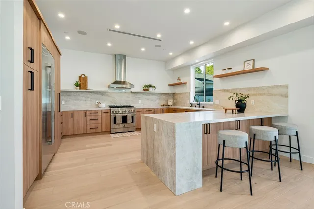 a kitchen with stainless steel appliances kitchen island granite countertop a sink and cabinets