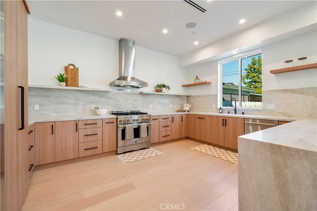 a large kitchen with stainless steel appliances lots of counter top space