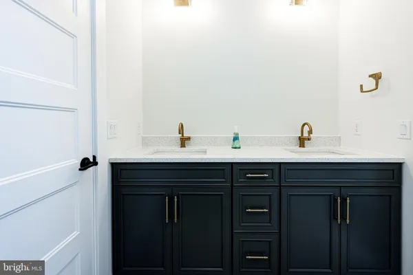 a view of an empty room with wooden floor and closet