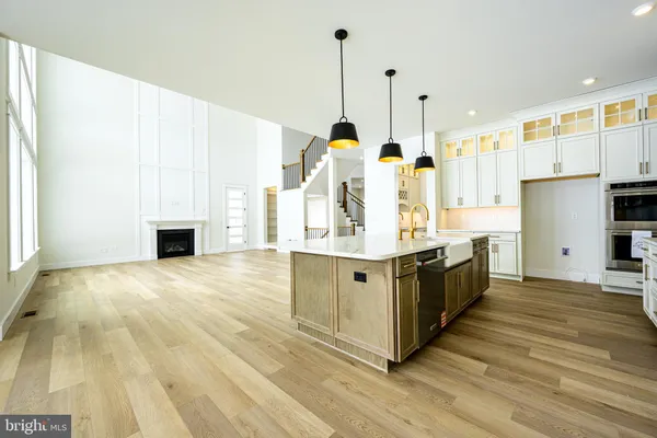 a kitchen with a stove a refrigerator and a fireplace
