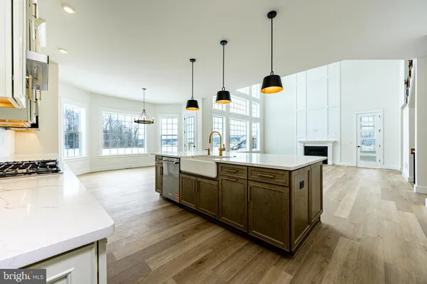 a large kitchen with kitchen island granite countertop wooden floors