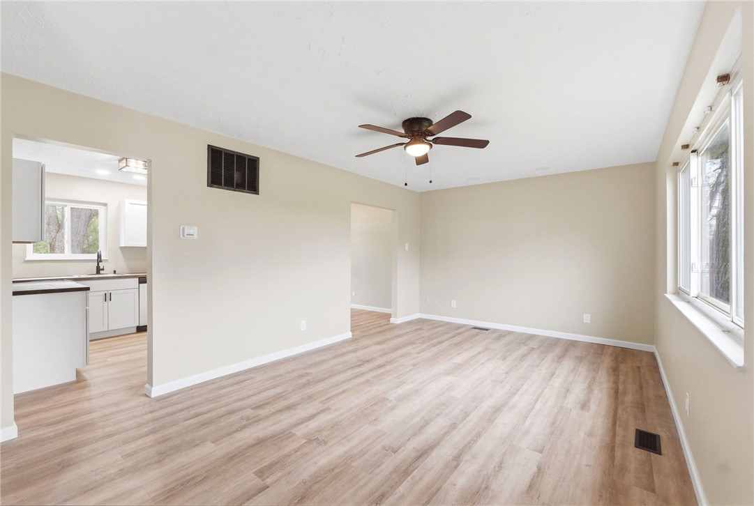 40 Woods Road Springboro, OH 45066 - Photo 33 of 57 This bright living space features wood flooring and a modern ceiling fan, seamlessly connecting to the adjacent kitchen.