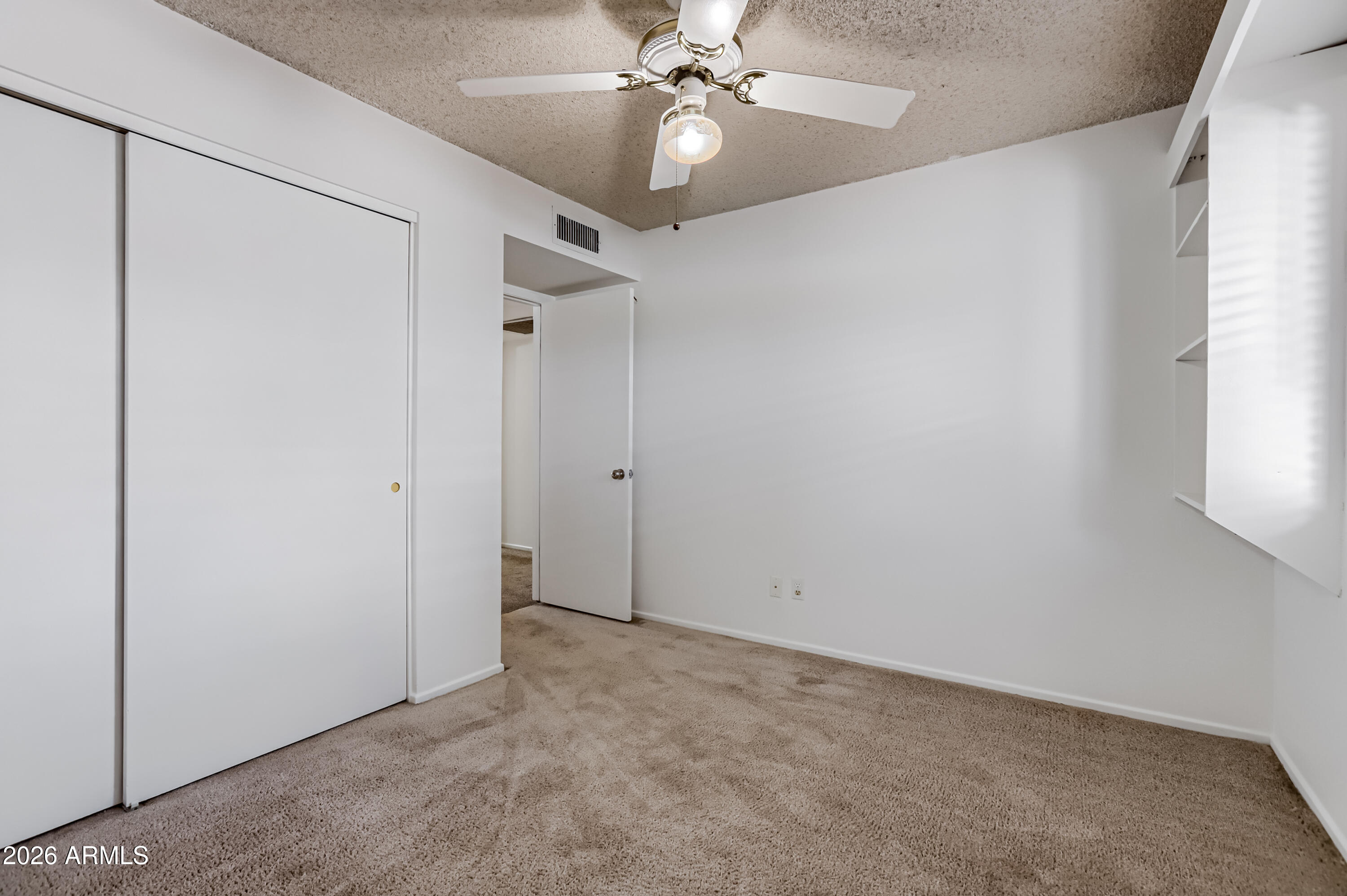 3823 West Greenway Road Phoenix, AZ 85053 - Photo 18 of 28 an empty room with a fan and a fan