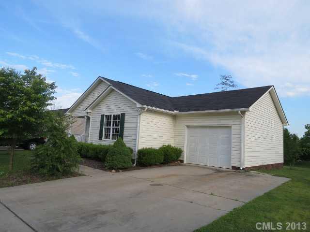 a view of a house with a yard and garage