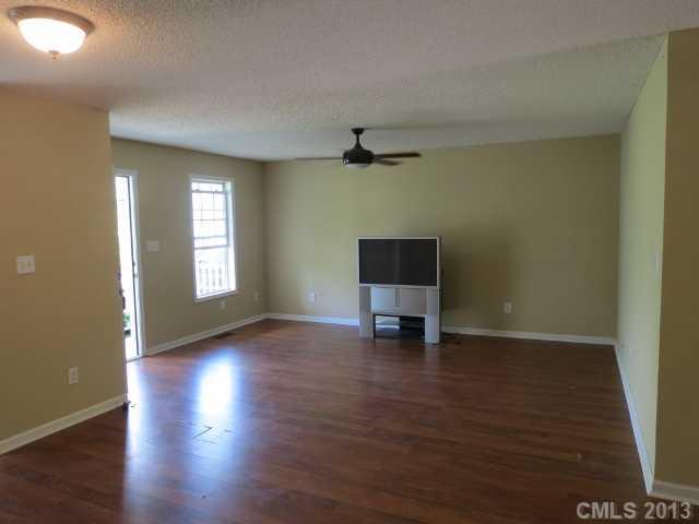 1015 Piney Church Road Concord, NC 28025 - Photo 4 of 13 a view of an empty room with window and wooden floor