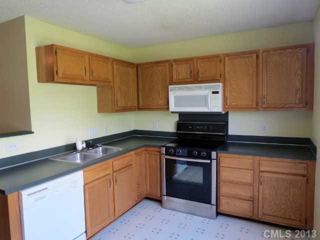 1015 Piney Church Road Concord, NC 28025 - Photo 6 of 13 a kitchen with stainless steel appliances granite countertop a stove a sink and a microwave