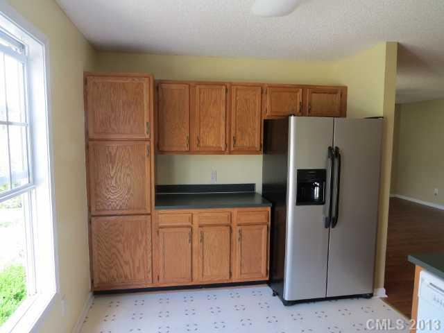 1015 Piney Church Road Concord, NC 28025 - Photo 7 of 13 a kitchen with stainless steel appliances granite countertop a refrigerator and a cabinets