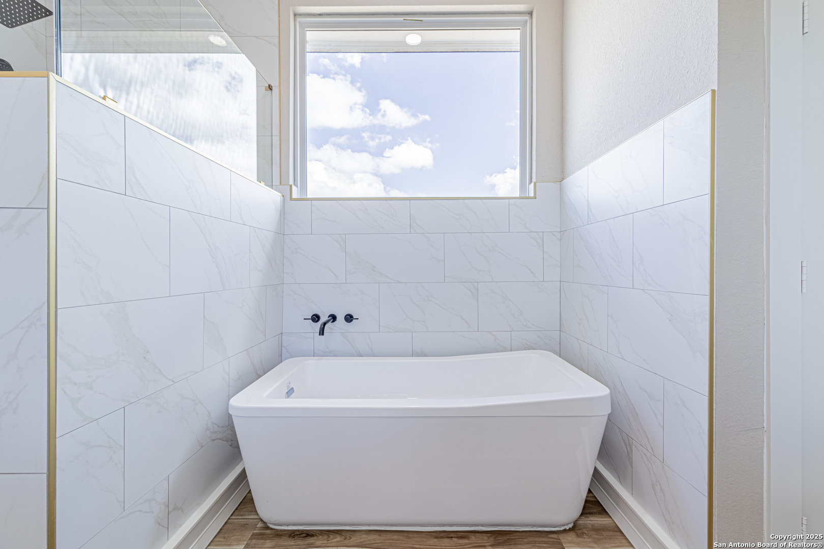 16923 Rancho Escondido Atascosa, TX 78002 - Photo 19 of 35 a white bath tub sitting in a bathroom next to a window