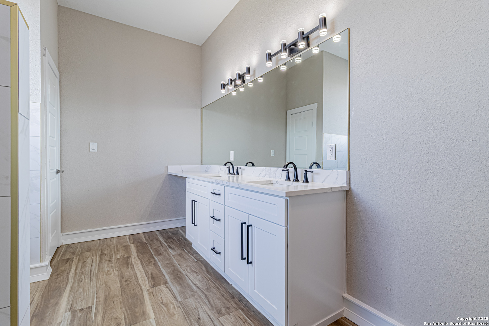 16923 Rancho Escondido Atascosa, TX 78002 - Photo 21 of 35 a spacious bathroom with a double vanity sink and a mirror
