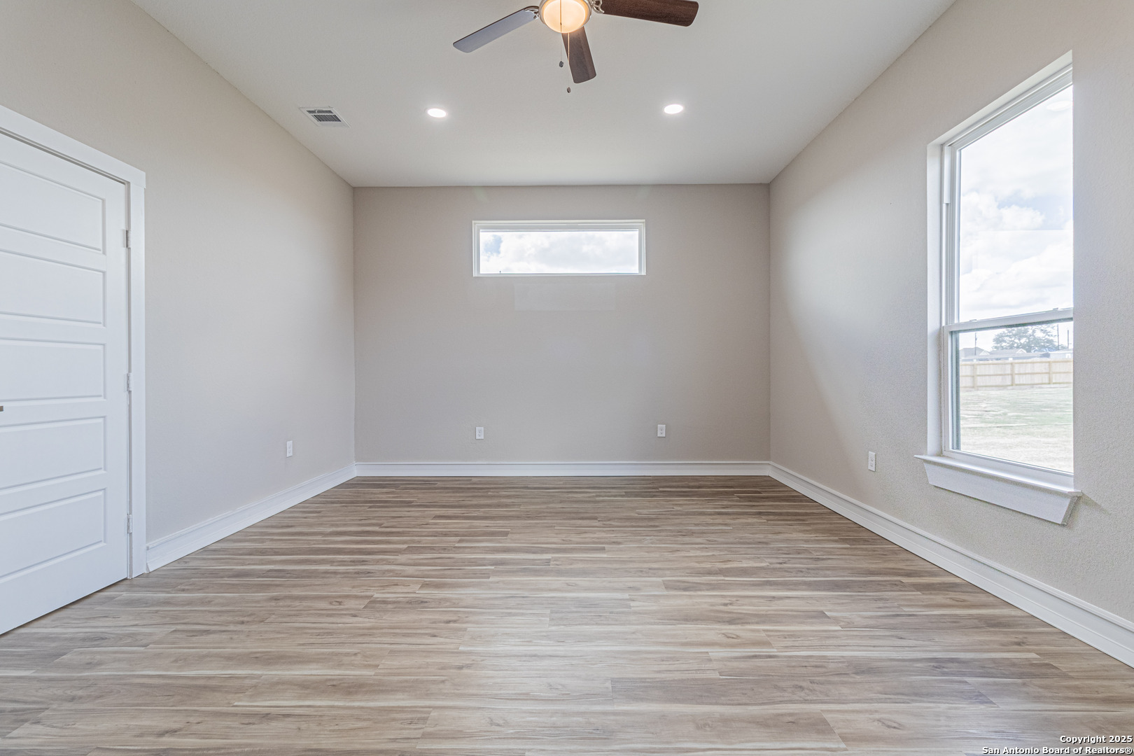 16923 Rancho Escondido Atascosa, TX 78002 - Photo 27 of 35 a view of an empty room with window and wooden floor