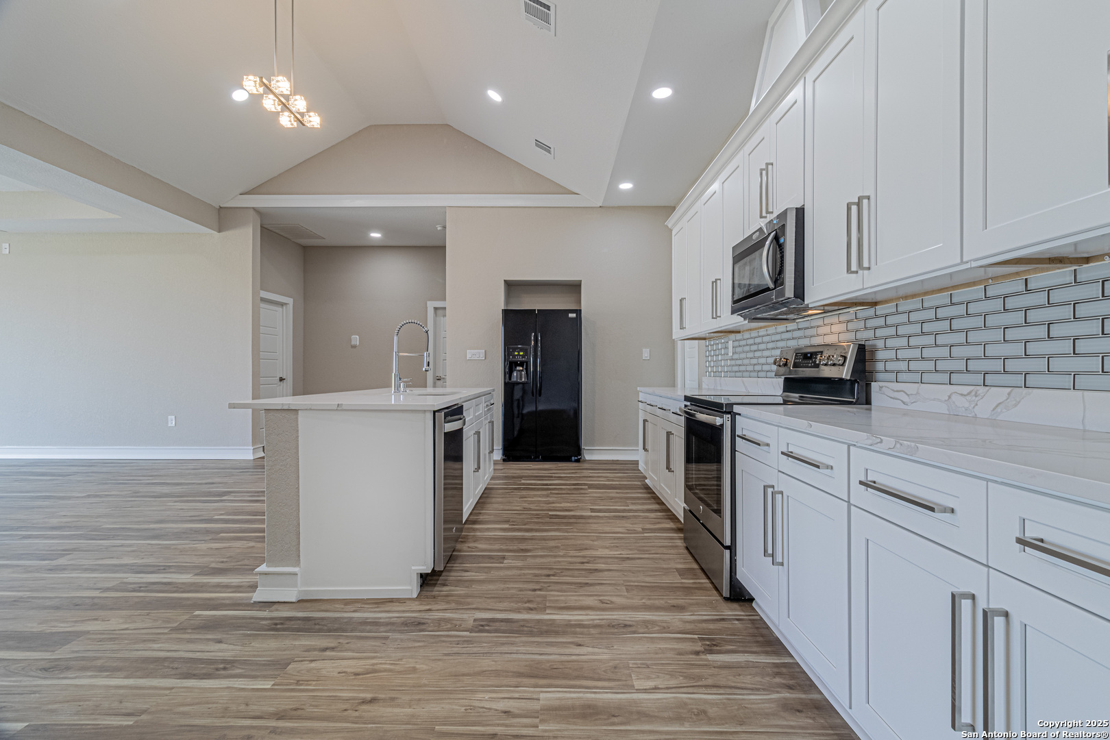 16923 Rancho Escondido Atascosa, TX 78002 - Photo 5 of 35 a large kitchen with stainless steel appliances granite countertop a large counter top and a stove top oven
