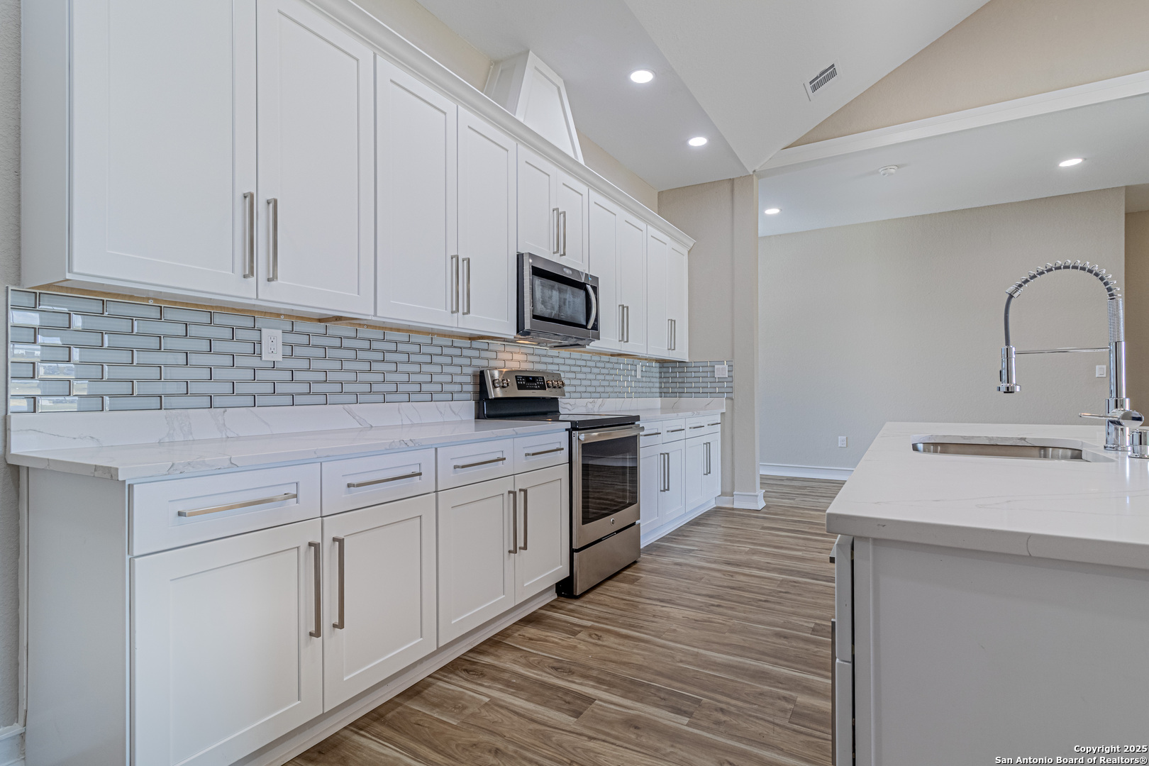 16923 Rancho Escondido Atascosa, TX 78002 - Photo 8 of 35 a kitchen with white cabinets stainless steel appliances and sink