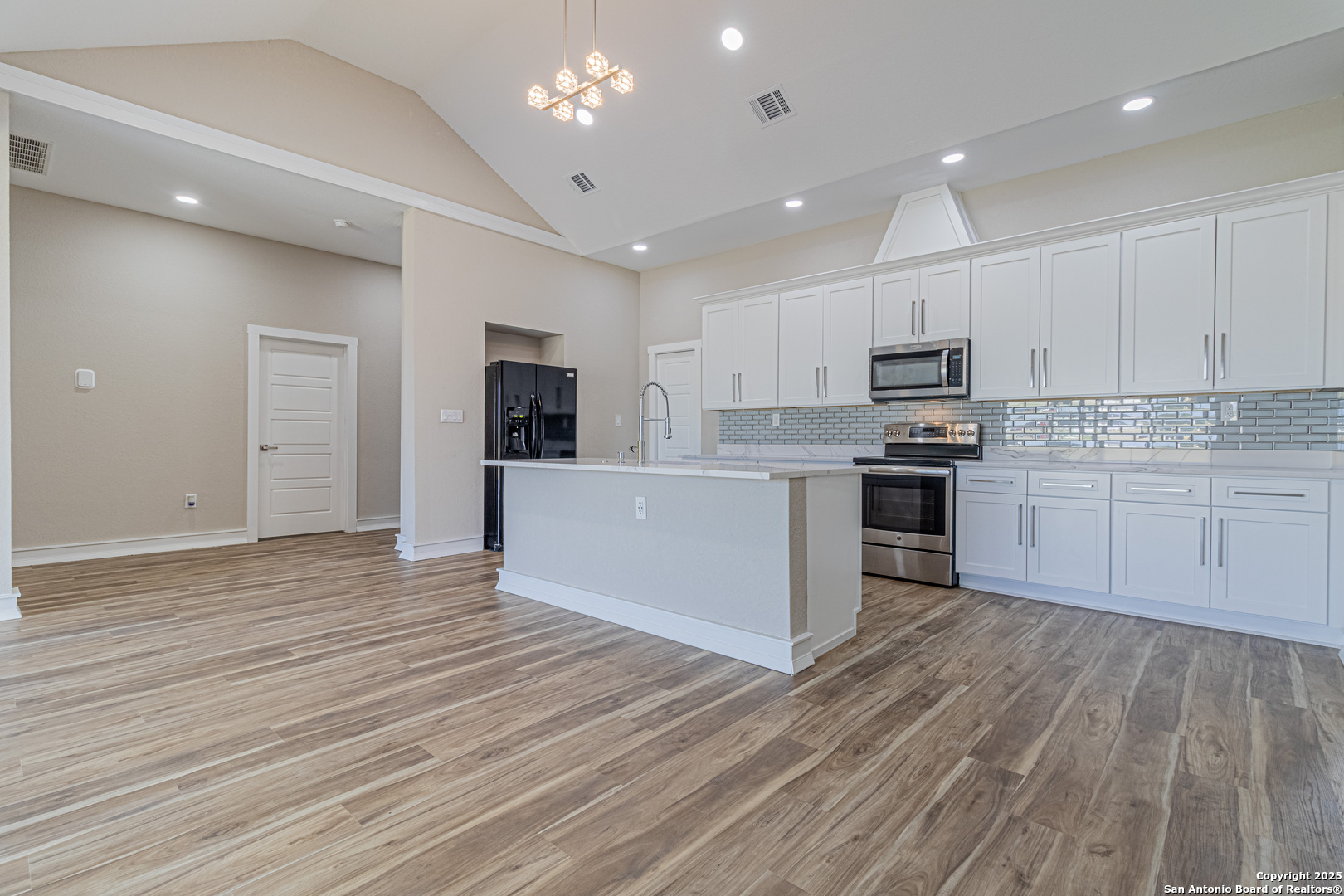 16923 Rancho Escondido Atascosa, TX 78002 - Photo 9 of 35 a view of kitchen with wooden floor and electronic appliances