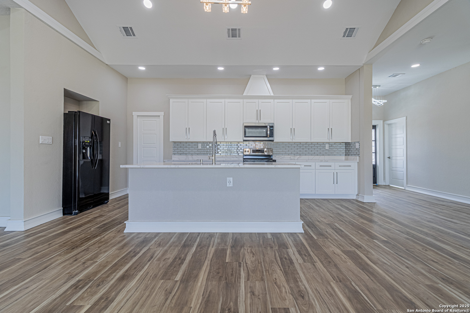 16923 Rancho Escondido Atascosa, TX 78002 - Photo 10 of 35 a large kitchen with stainless steel appliances kitchen island a large counter top and a refrigerator