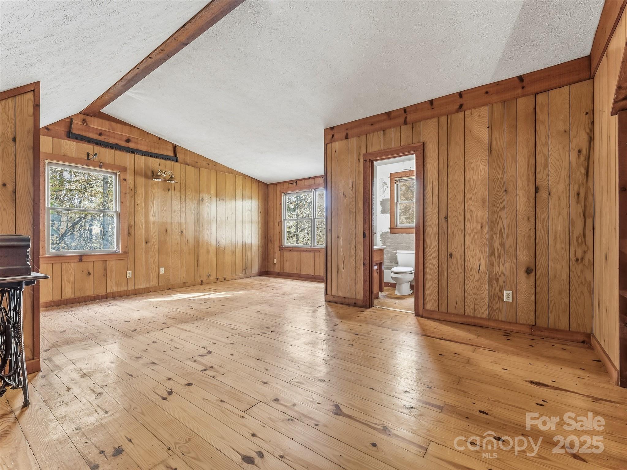 6130 Howard Gap Road Saluda, NC 28773 - Photo 11 of 27 a view of an empty room with wooden floor and a window